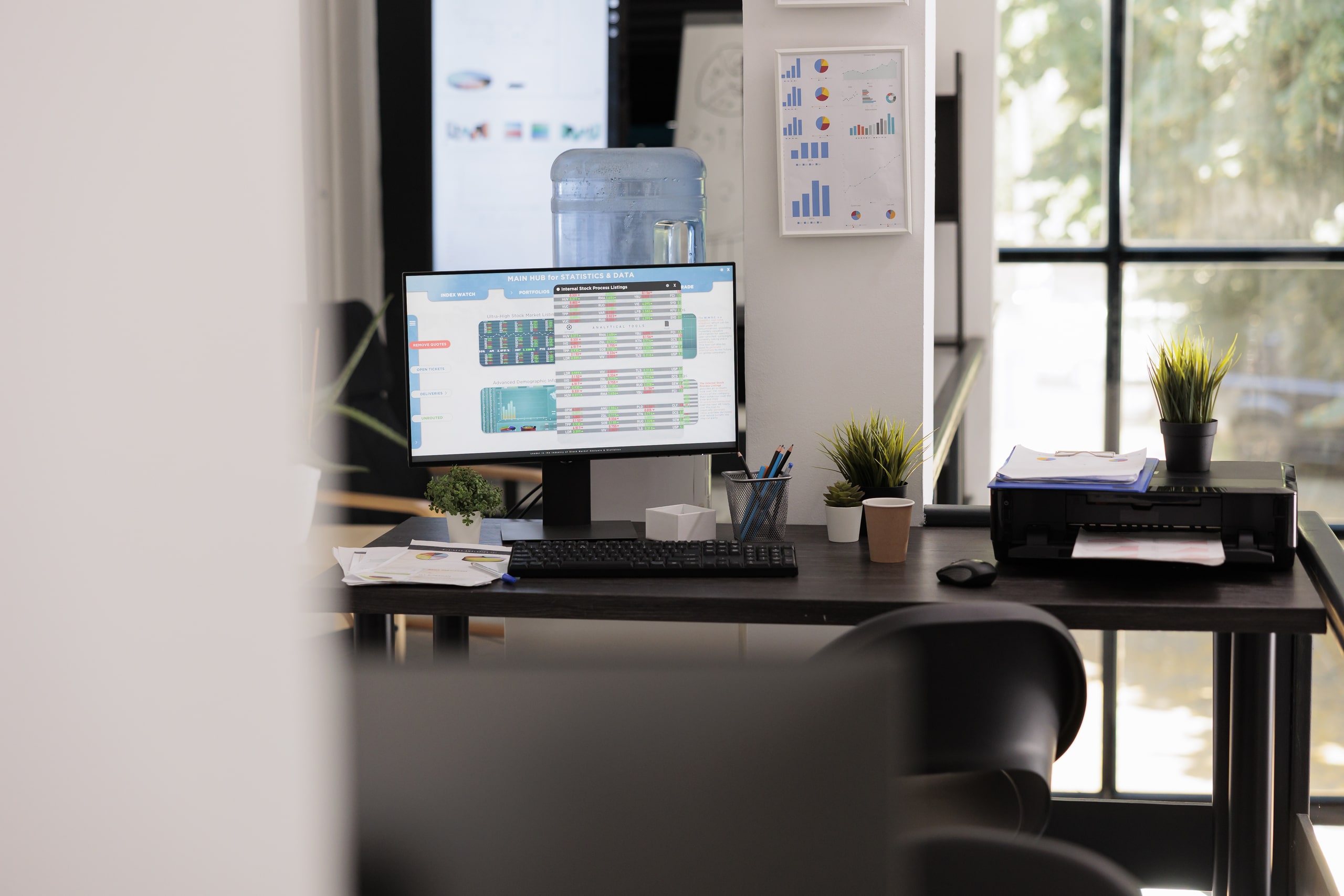 Oficina Moderna Dedicada Al Proceso De Reporte Y Seguimiento De Operaciones Sospechosas Espacio de oficina con escritorio organizado, computadora mostrando gráficos y reportes financieros, plantas decorativas y documentos, enfatizando el entorno profesional donde se realiza el proceso de reporte y seguimiento de operaciones sospechosas para fortalecer la seguridad financiera y el monitoreo regulatorio.